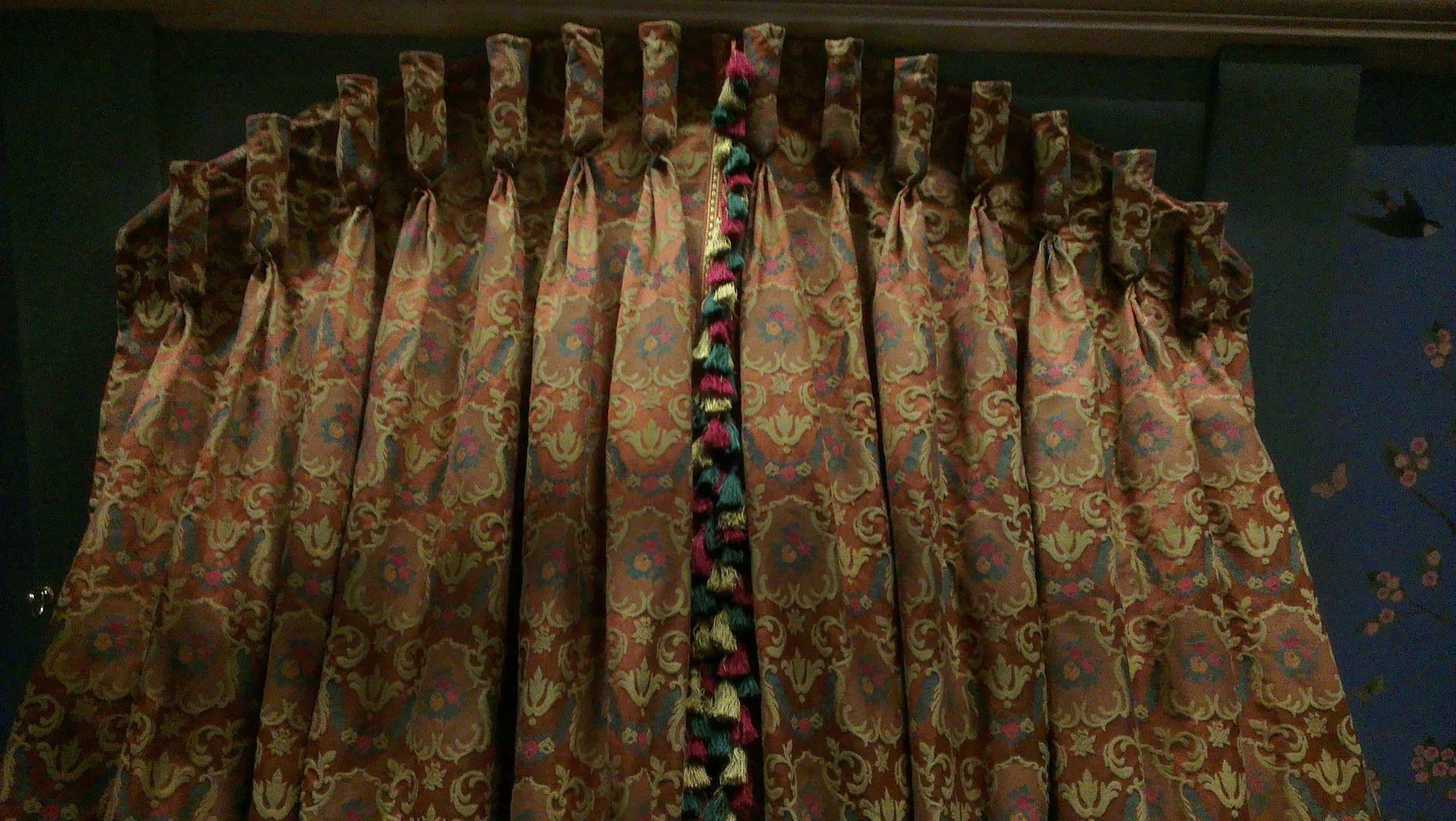 Ornate goblet pleat curtains fitted in an arch on the evil step sisters set.