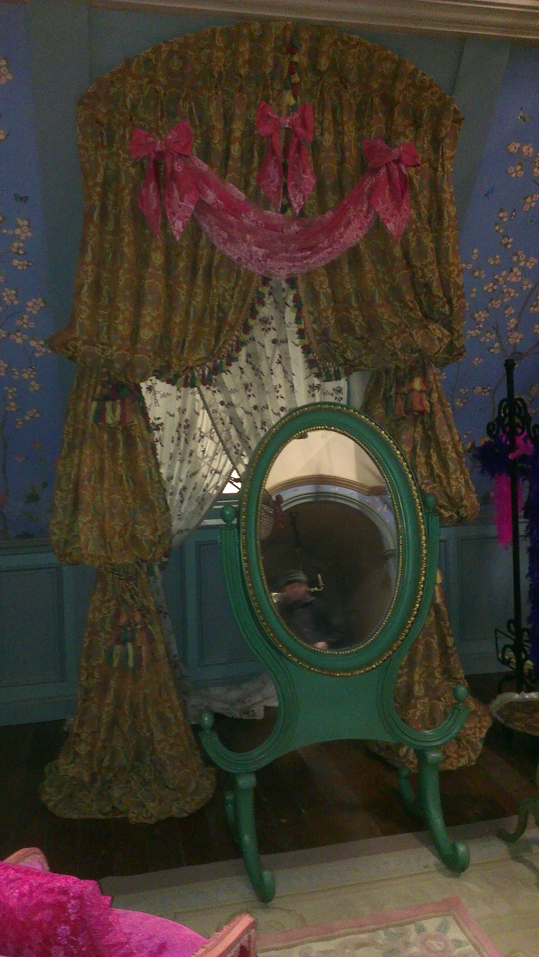 Ornate goblet pleat curtains fitted in an arch on the evil step sisters set.