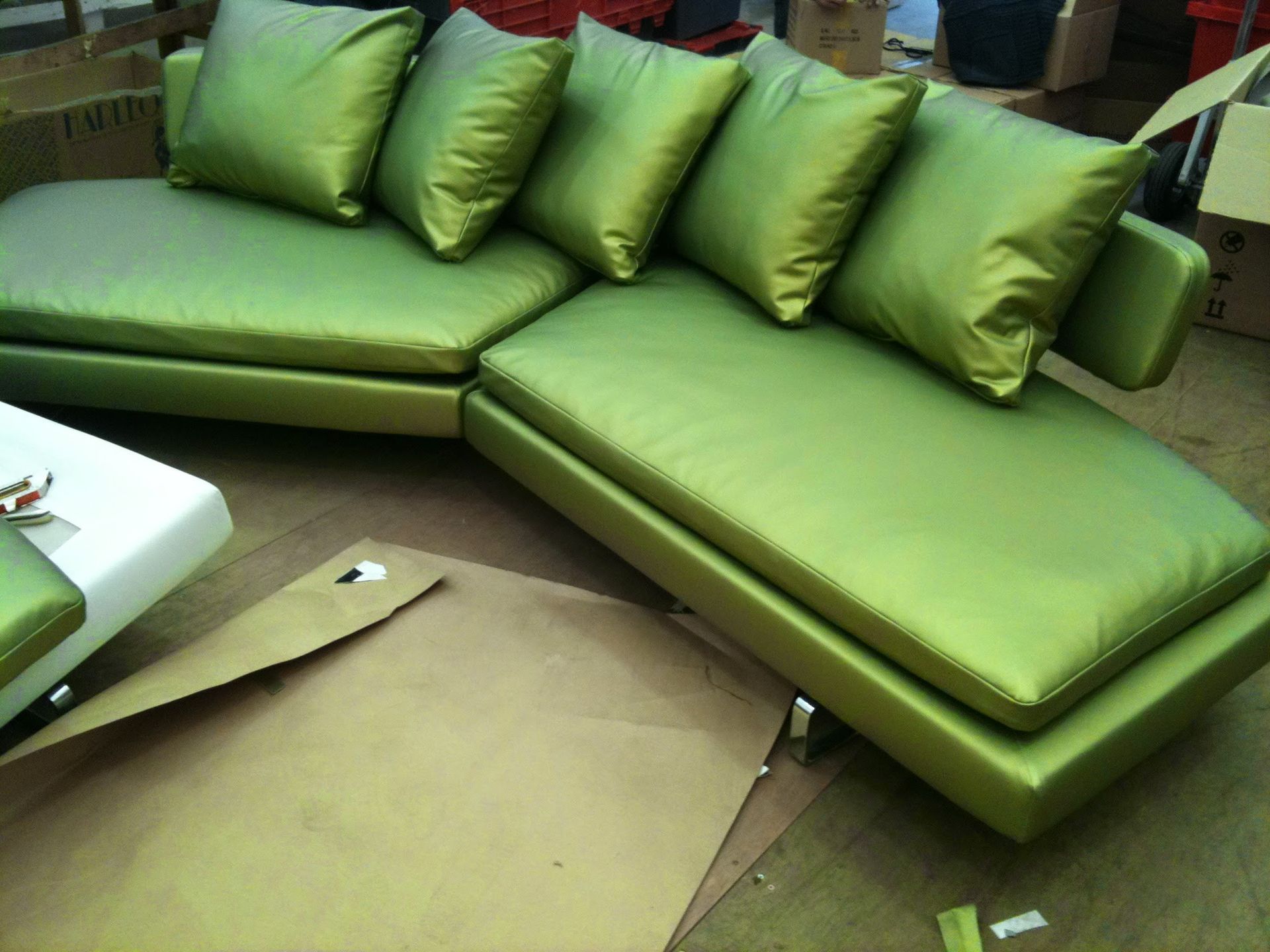 An upholstered, shiny fabric, modern, sofa from