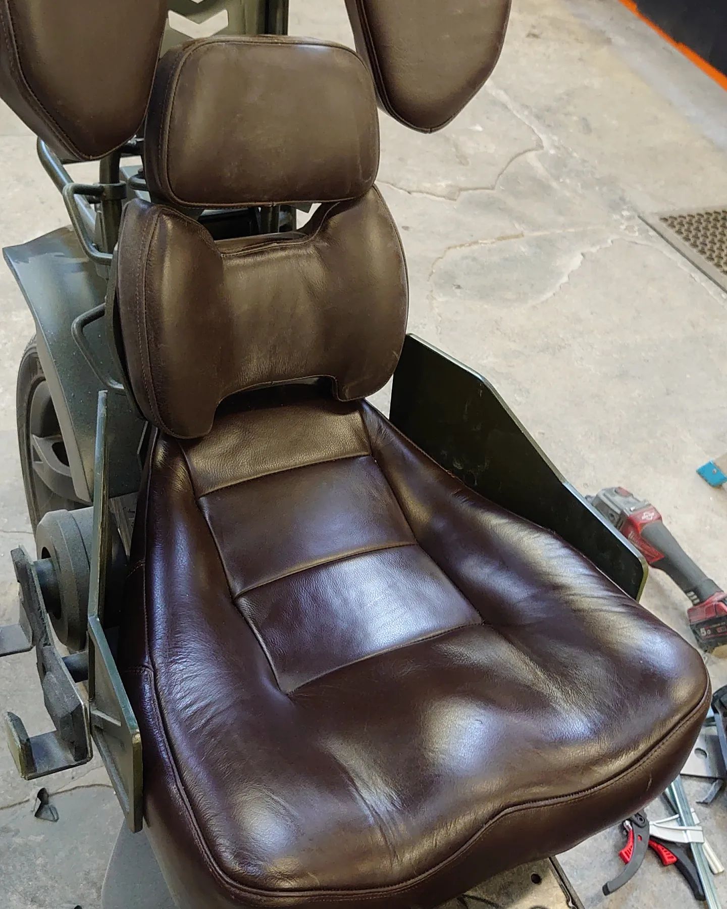 A vehicle seat made up of many shaped leather pads for