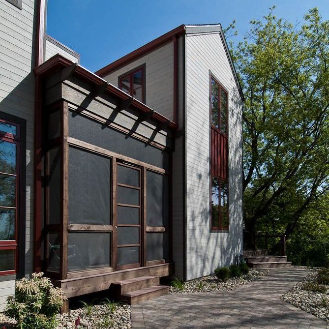 A house with a screened in porch and stairs