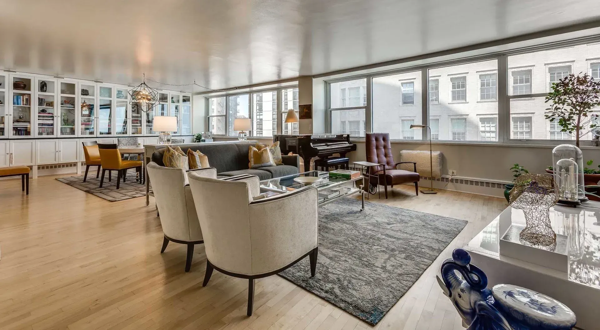 A living room filled with furniture and a lot of windows.