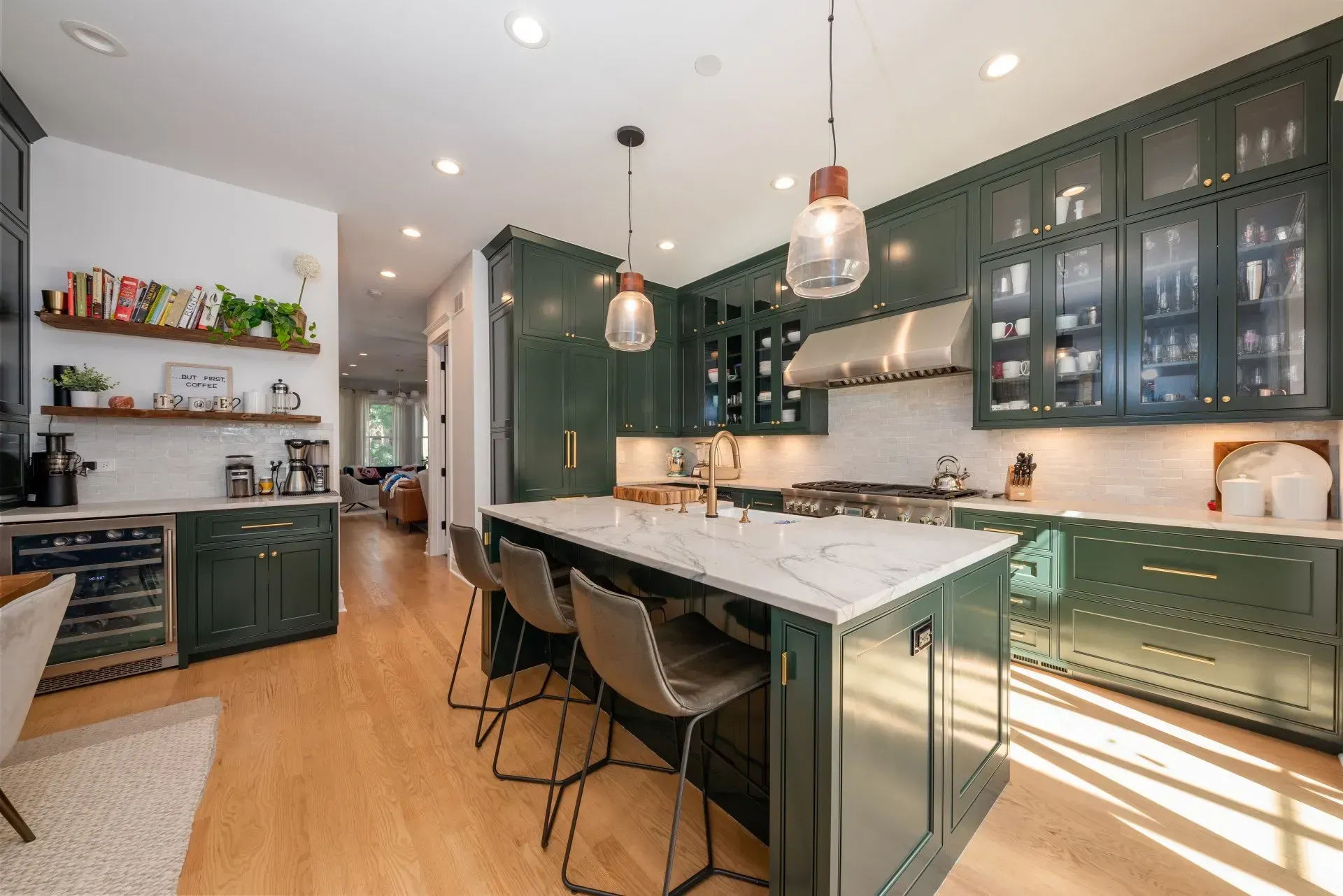 A kitchen with green cabinets and a large island.