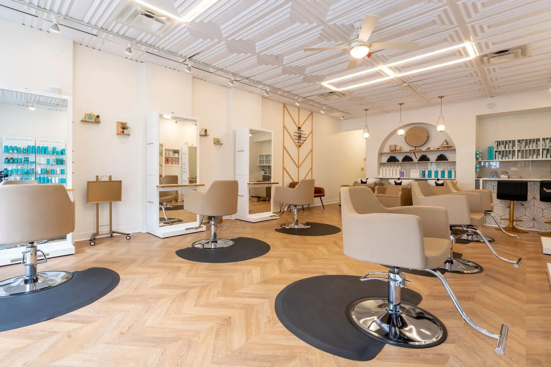 A salon with a lot of chairs and tables in it.