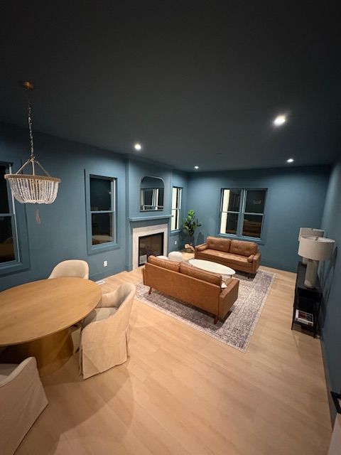 A living room with a couch , table and chairs