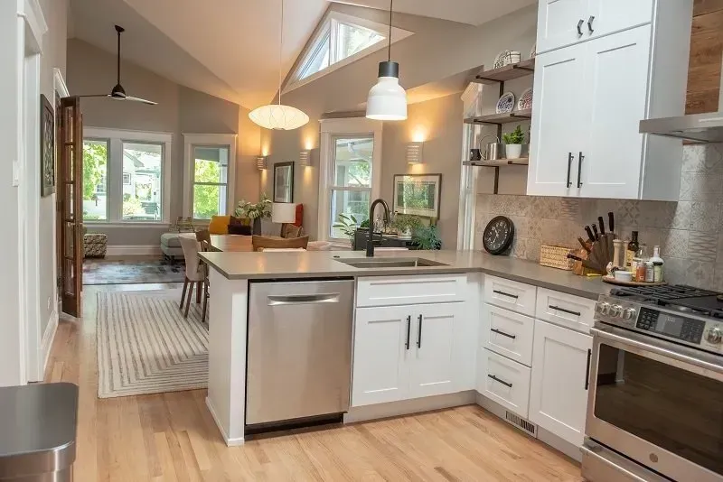 A kitchen with white cabinets and stainless steel appliances.