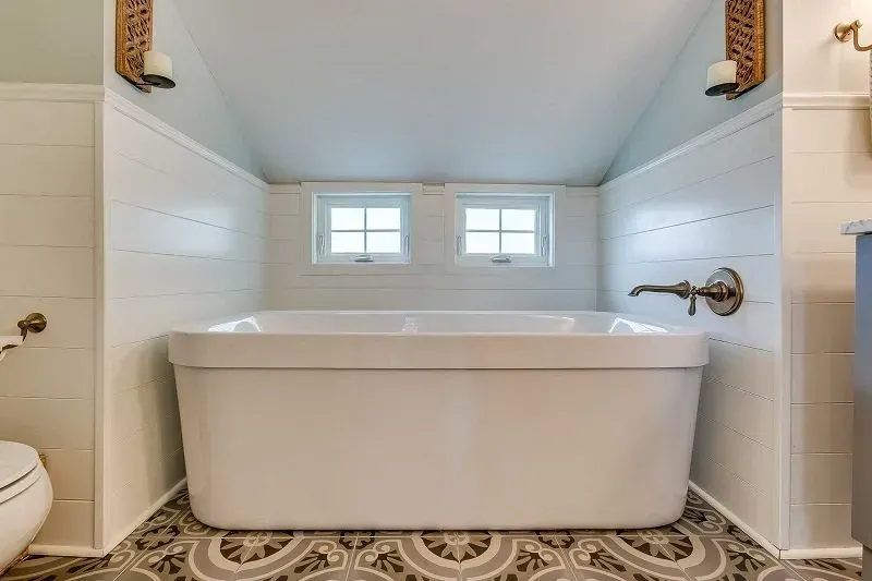 There is a bathtub in the middle of the bathroom.