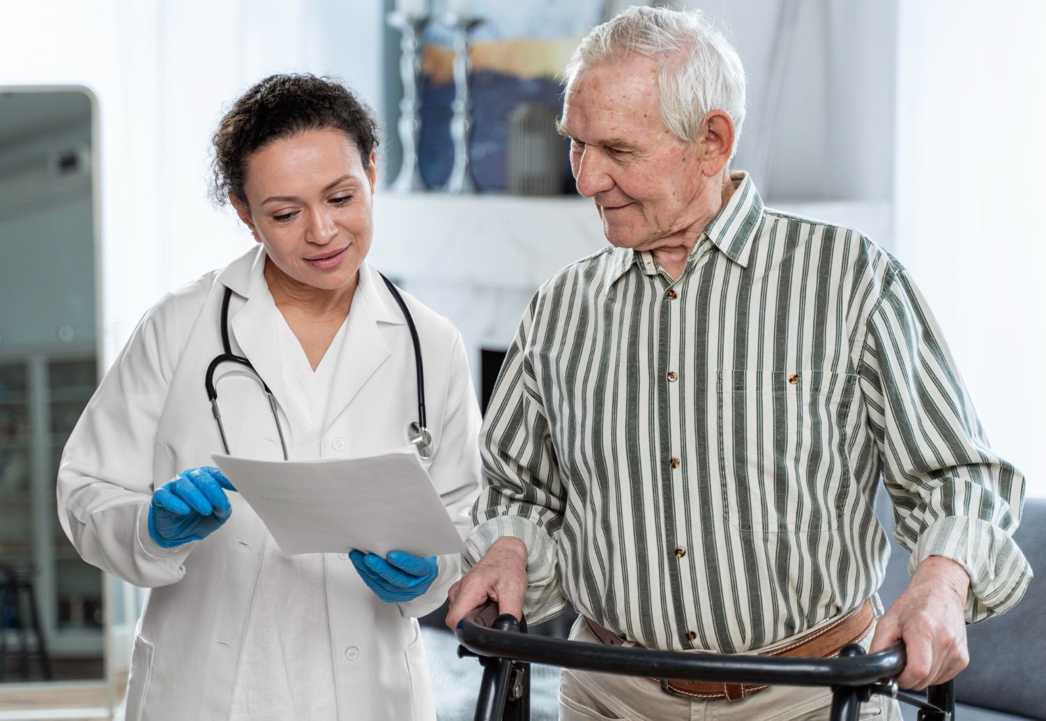 Doctor shows paperwork to a man using a walker. Both are inside, looking at the document.
