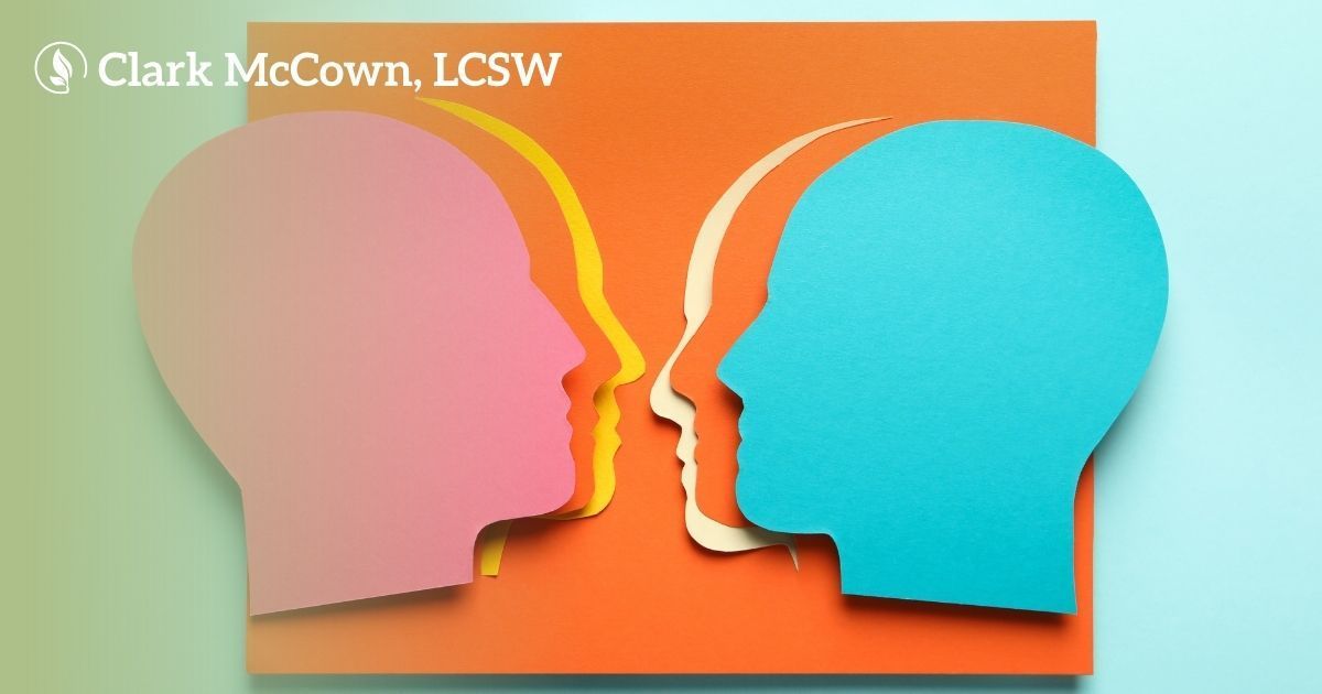 Two colorful human profile silhouettes facing each other on an orange and mint background