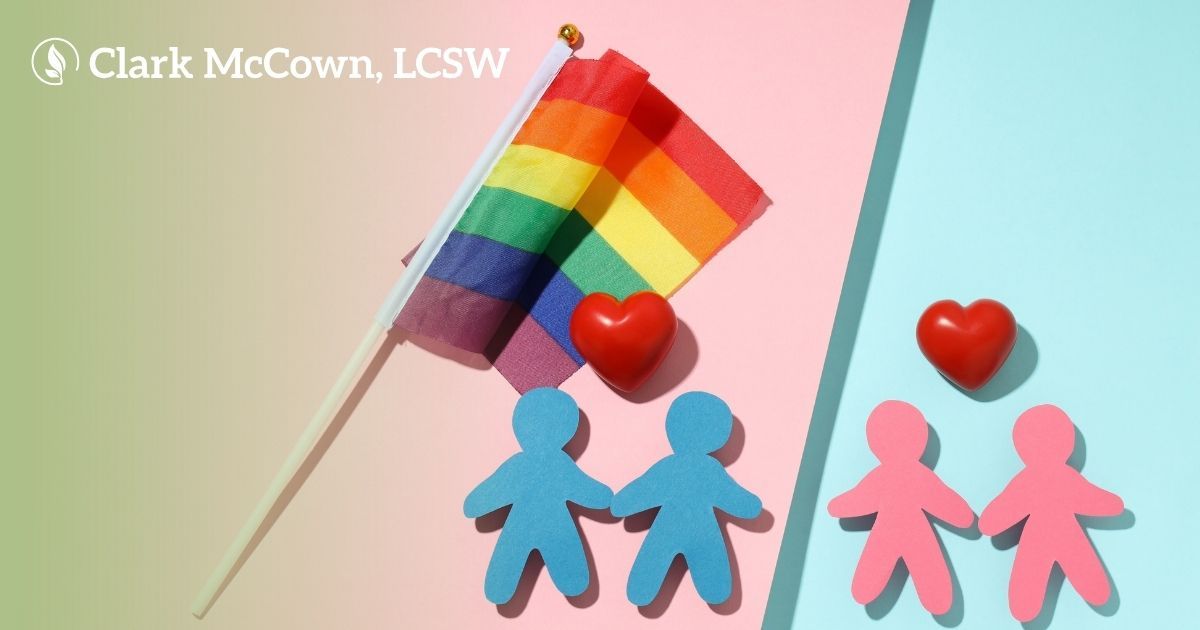 Rainbow flag with two blue and two pink person icons and red hearts on a pastel background
