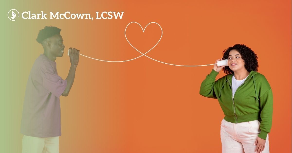 Two people using cup phones with a white heart string on an orange background