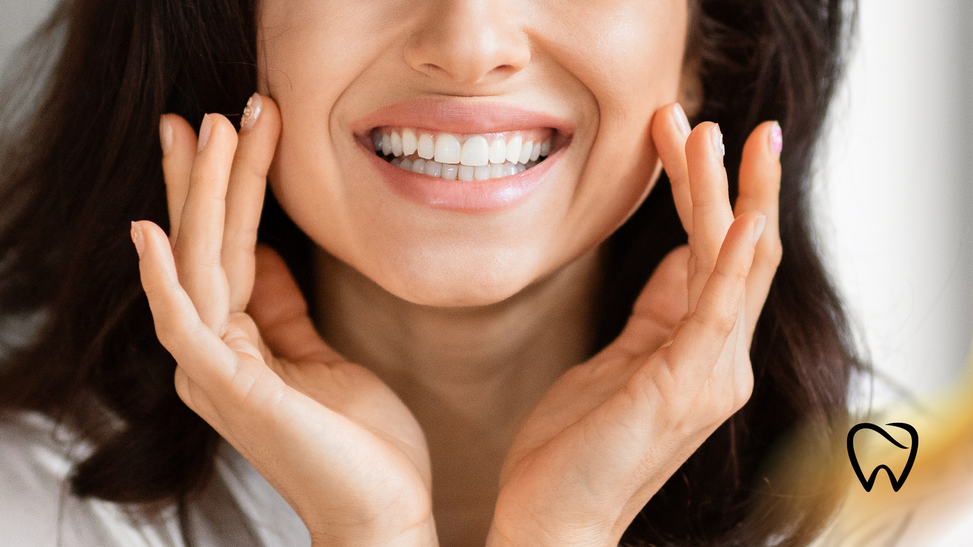 Woman smiling widely, touching cheeks, showing white teeth.