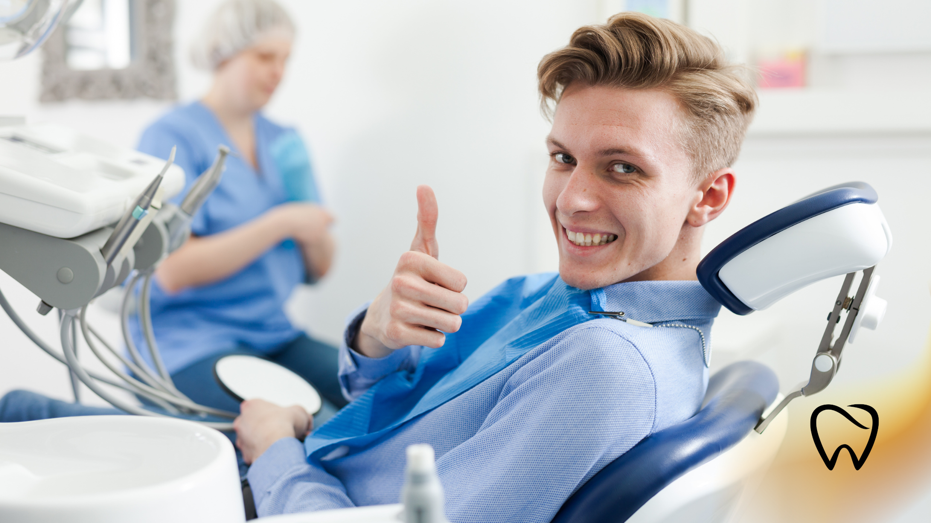 Patient smiling and giving a thumbs-up in a dental chair, with a dentist blurred in the background