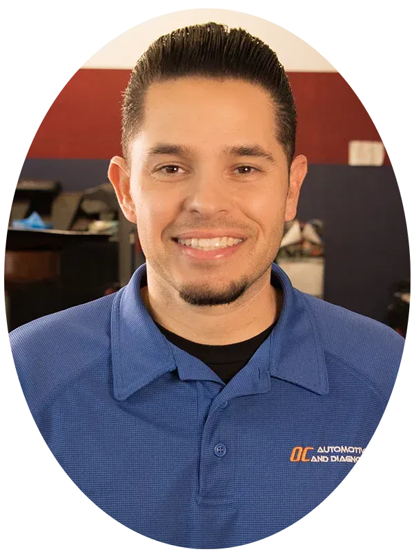 Smiling person in a blue collared shirt with a small logo | O.C. Automotive and Diagnostics