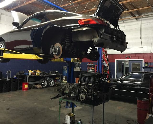 Car in an auto repair shop lifted on a hydraulic hoist | O.C. Automotive and Diagnostics