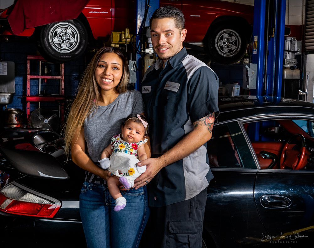 Family posing in an auto shop | O.C. Automotive and Diagnostics