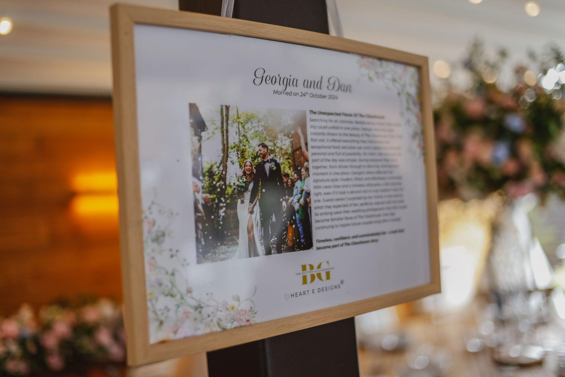 Framed wedding sign on an easel at a softly lit reception table with floral décor