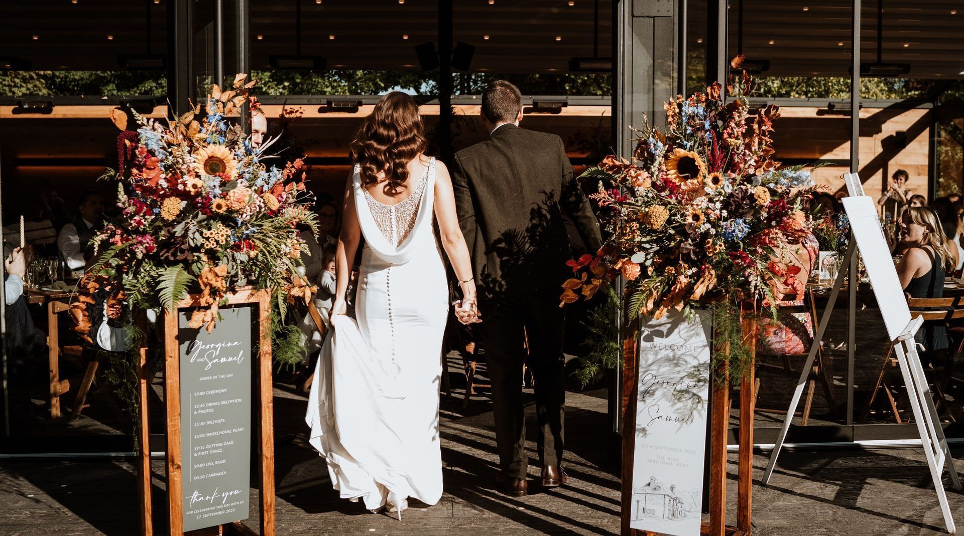 Bride and groom walking into their Glasshouse ceremony