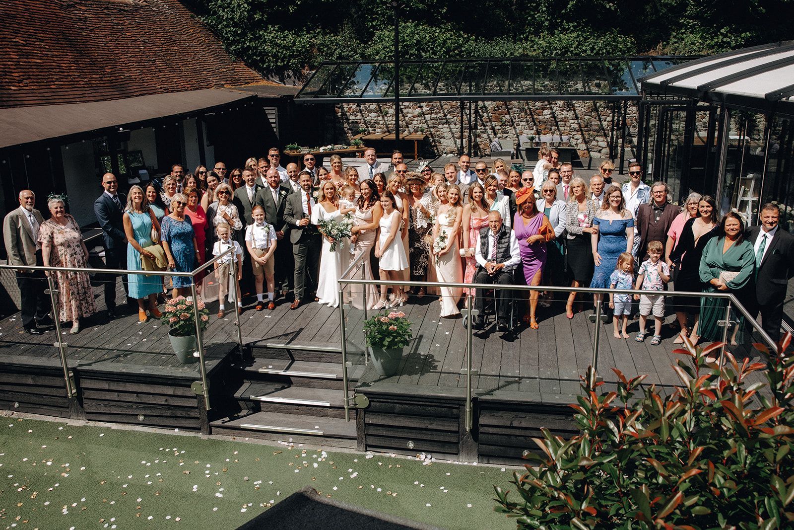 The wedding party on the outside terrace for a photo