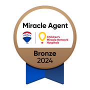 Bronze 2024 Miracle Agent badge with RE/MAX logo and Children's Miracle Network Hospitals, brown circle, blue ribbon.