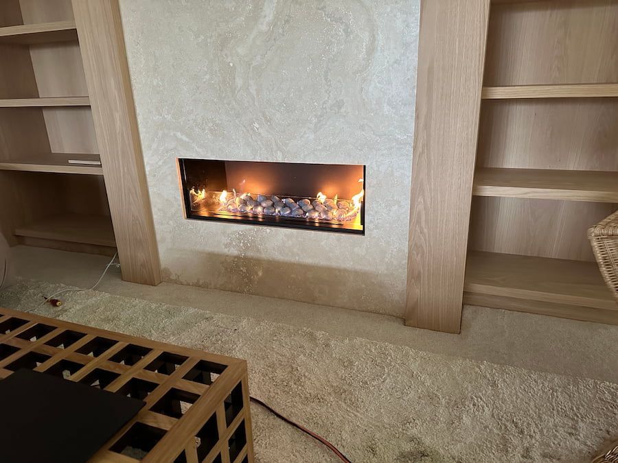 A Living Room With A Fireplace And A Coffee Table — Plumbmasters In Tweed Heads, NSW