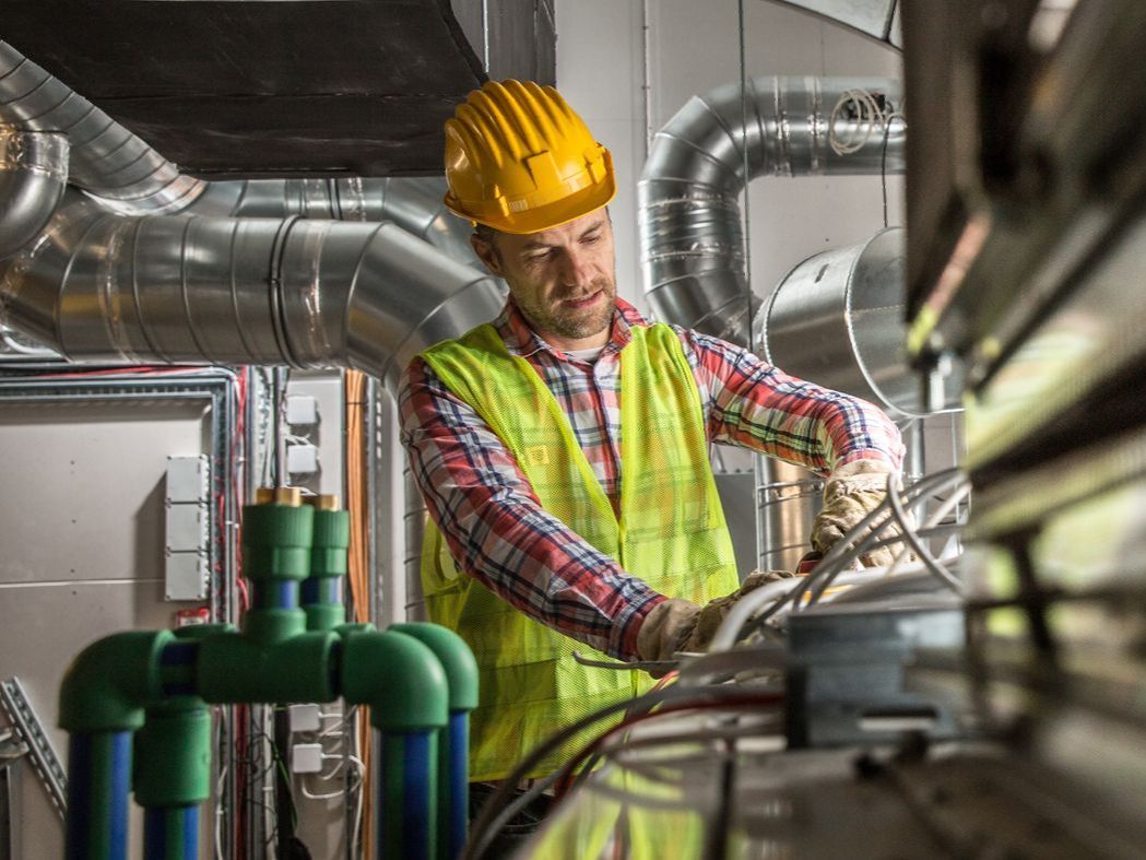 Technician repairing a duct