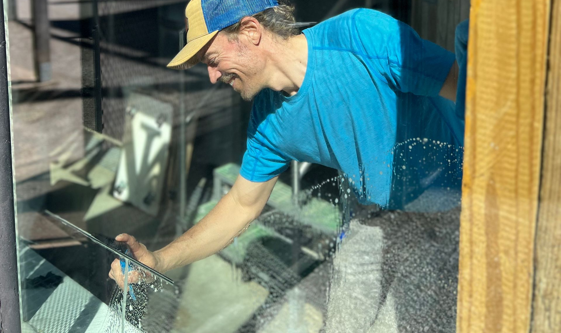 Professional cleaner using a squeegee on a large window
