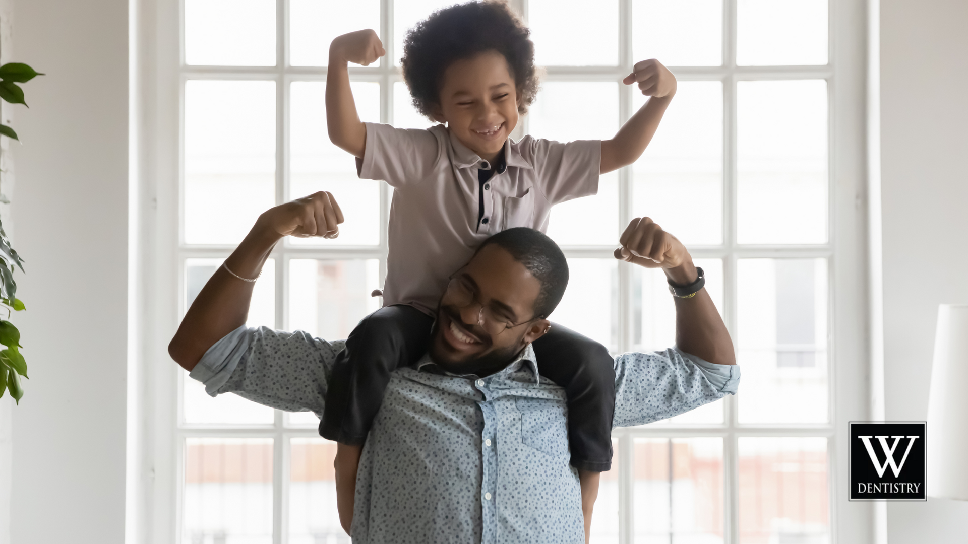 A man is carrying a little boy on his shoulders.