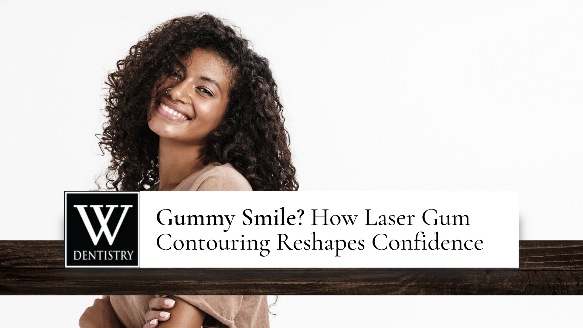 A woman with curly hair is smiling for the camera.