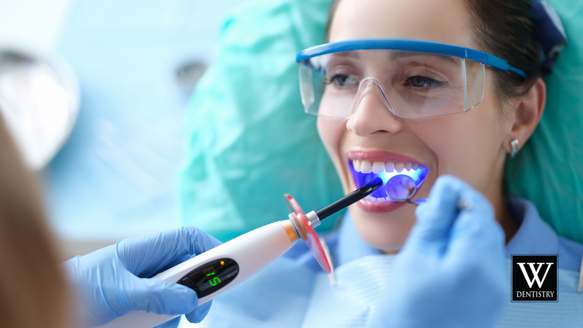 A woman is getting her teeth whitened by a dentist.
