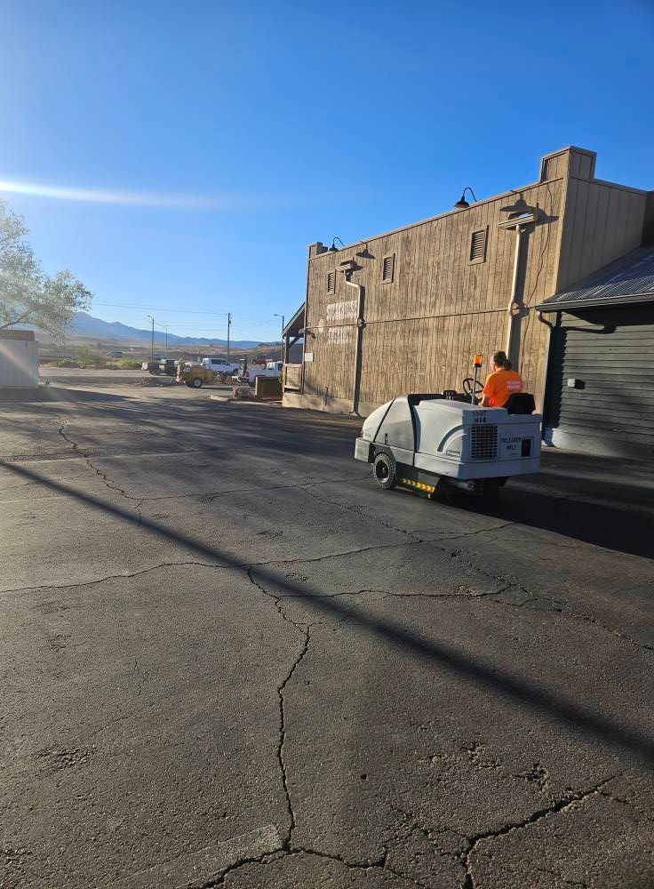 Street scene with a white utility cart by an old stone building under a clear blue sky