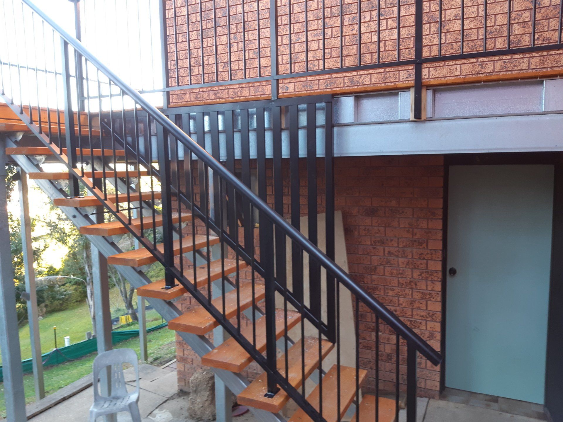 A Set Of Stairs Leading Up To A Brick Building — Boambee Home Improvements in Coffs Harbour, NSW
