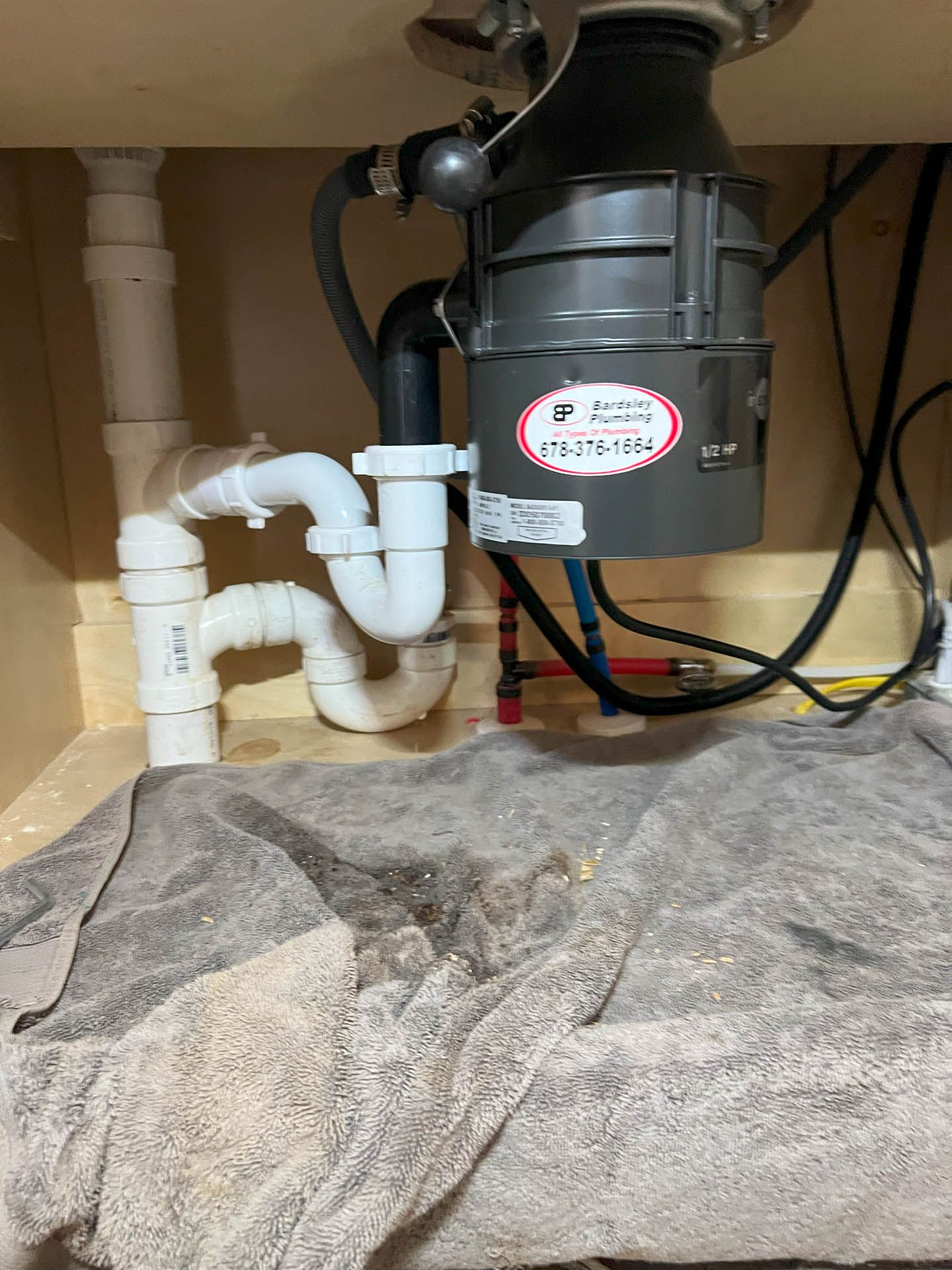 A garbage disposal is sitting under a sink in a kitchen.