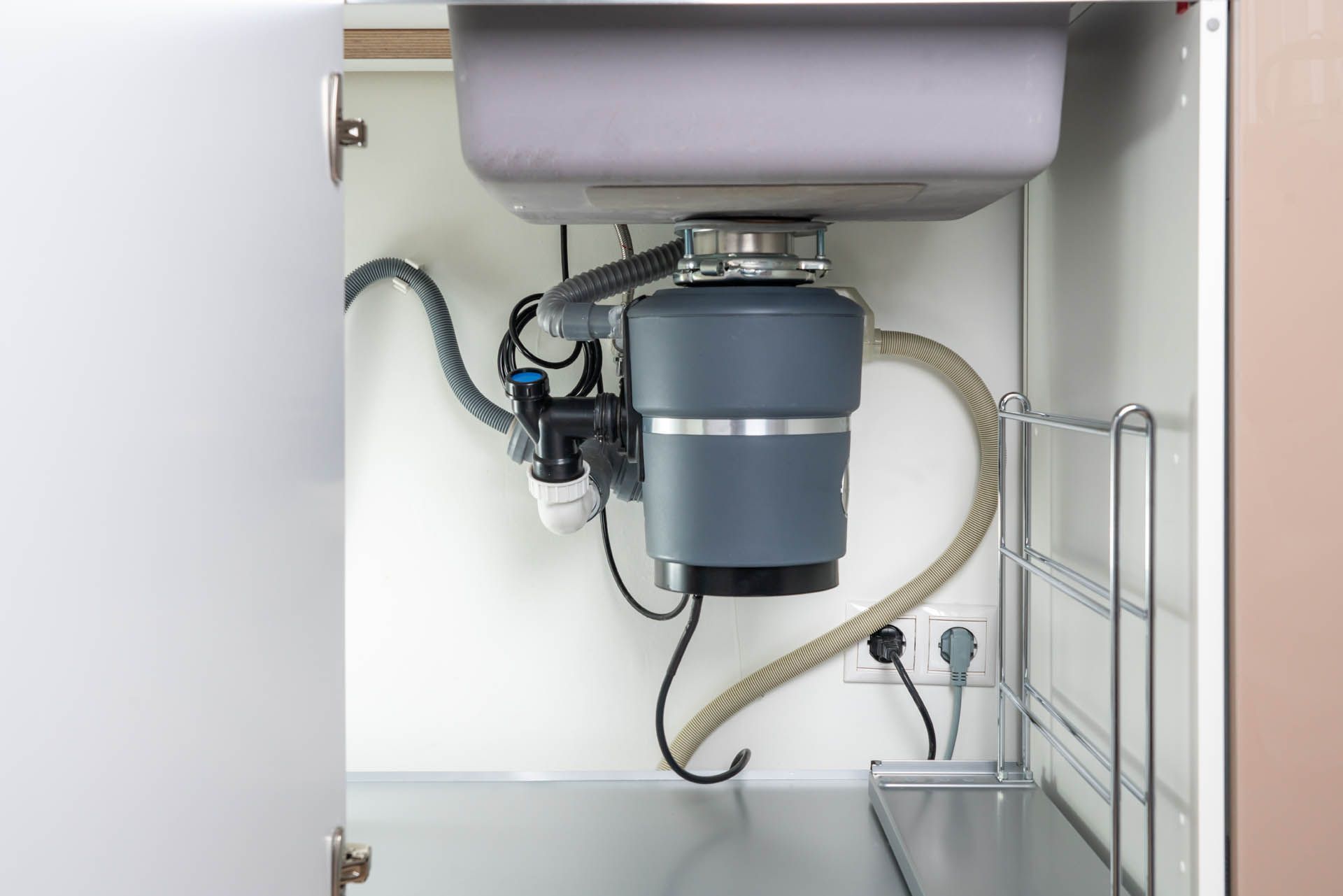 a kitchen sink with a garbage disposal underneath it.