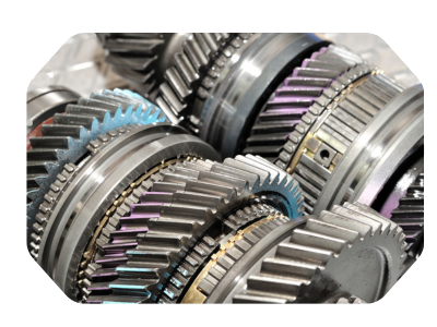 Close-up of interlocking metallic gears with blue and purple markings