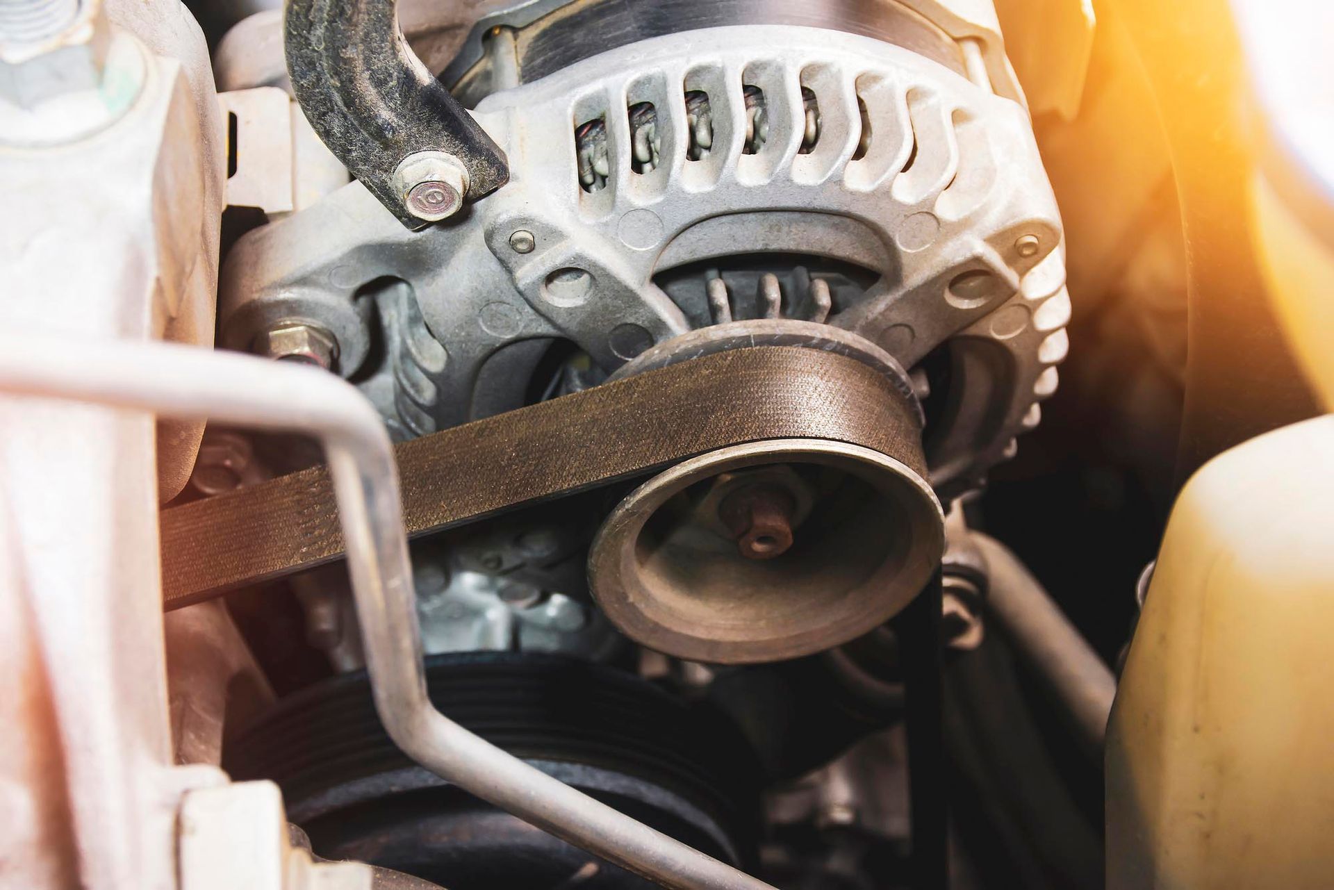 Car engine with alternator and serpentine belt in close-up view