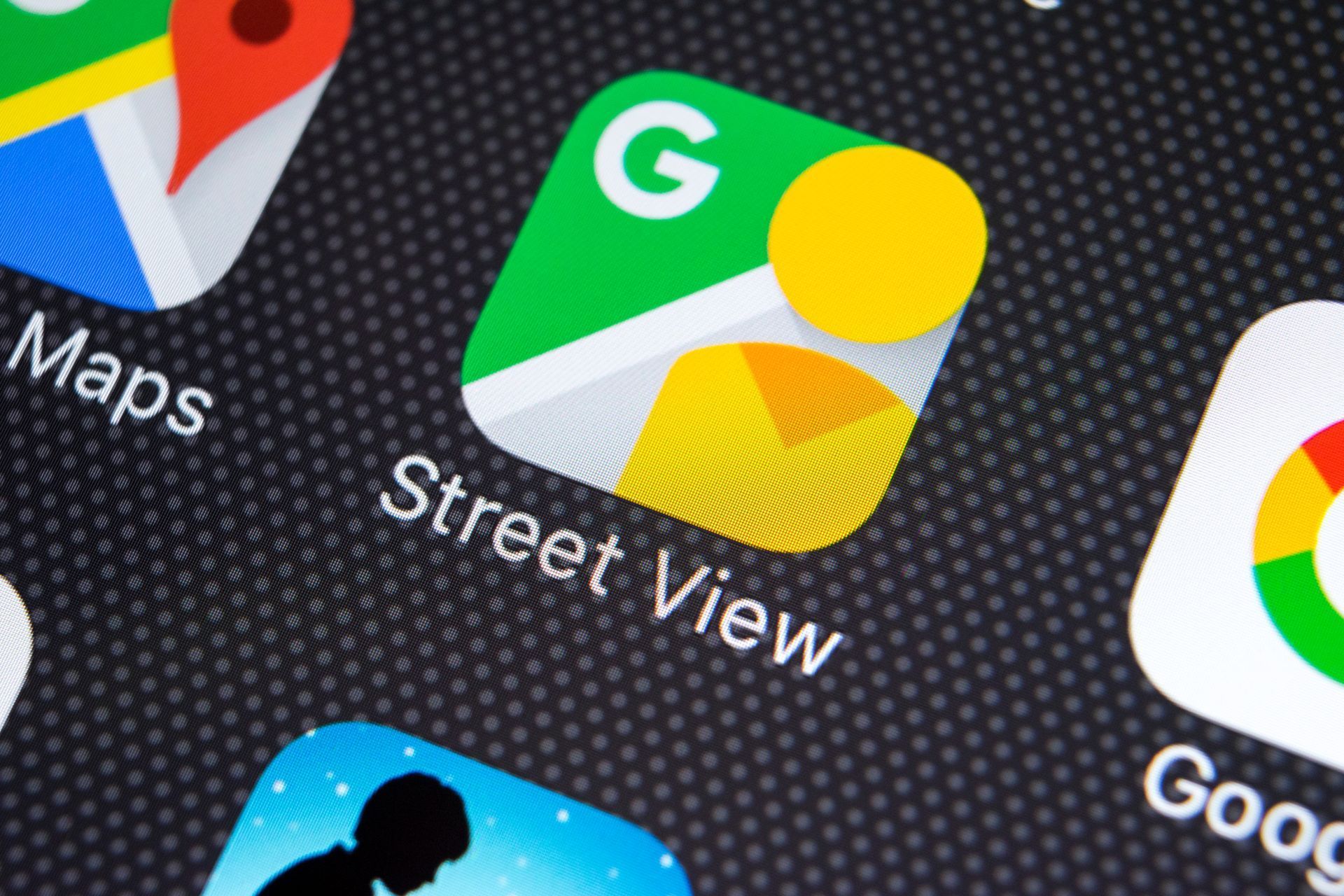 Google Street View app icon on a smartphone screen, green, yellow, and white graphic.