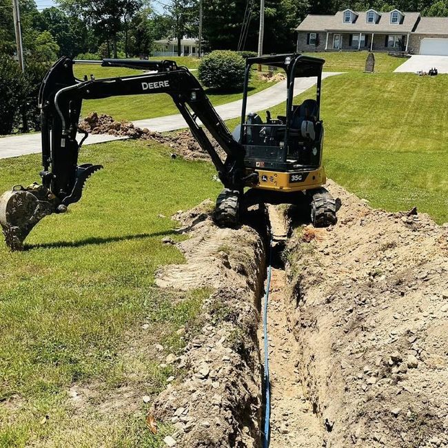 A small excavator is digging a hole in the ground.