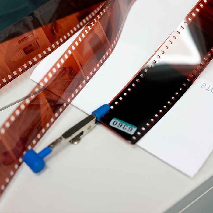 Photographer holding a developed film negative - film processing services at Fort Worth Camera in Fort Worth, TX 
