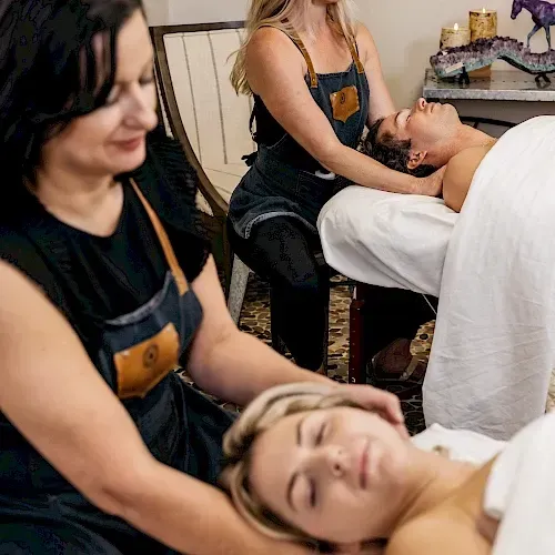 A woman is giving a man a massage in a spa.