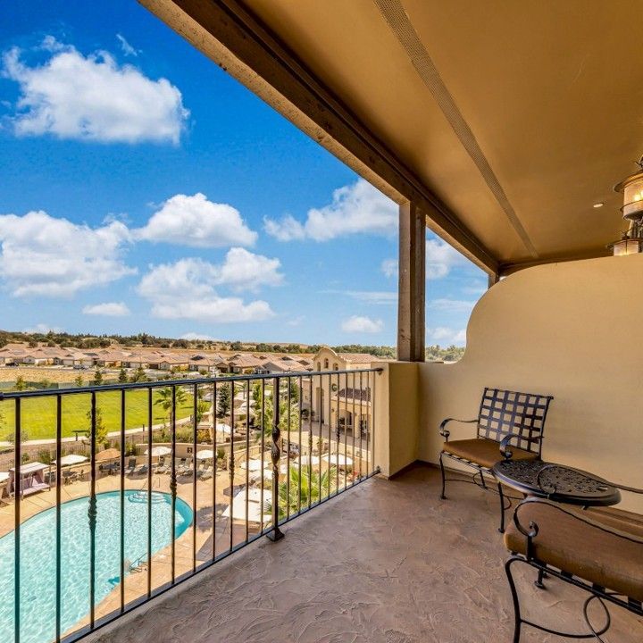 A balcony with a view of a swimming pool