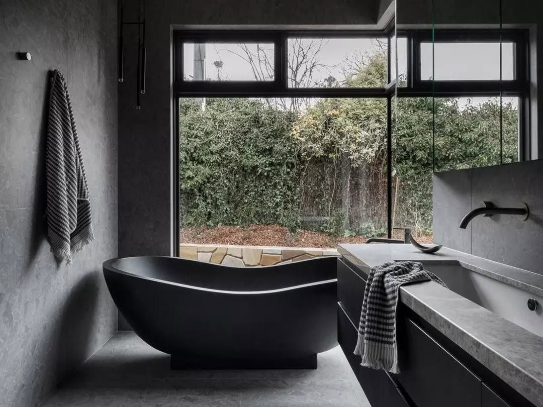 Modern Bathroom with Black Freestanding Tub, Large Window, and View of Greenery Outdoors — Complete Property Projects In Phillip, ACT