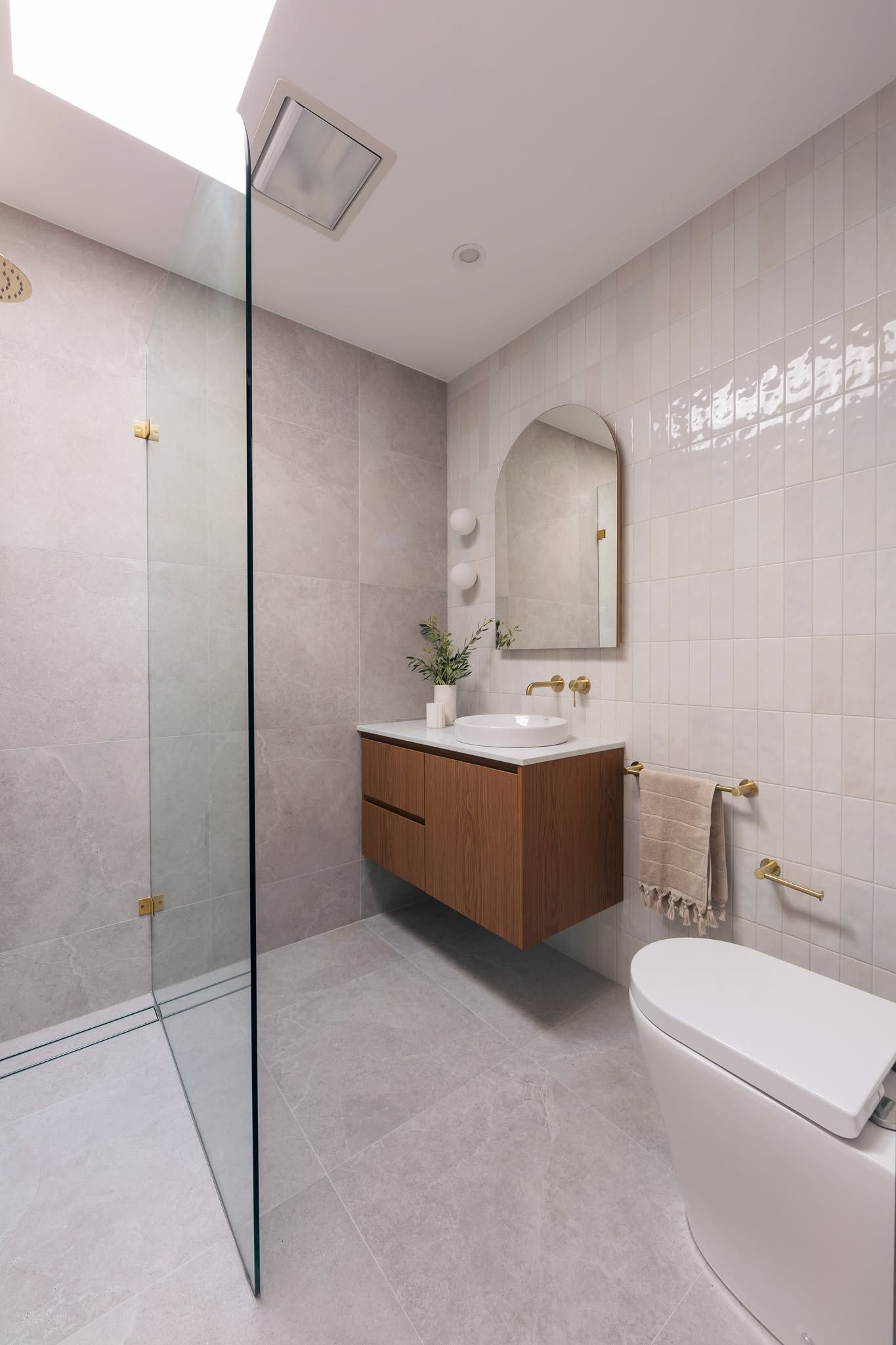 Modern Bathroom with Glass Shower, Floating Wood Vanity, Mirror, and Toilet — Complete Property Projects In Phillip, ACT