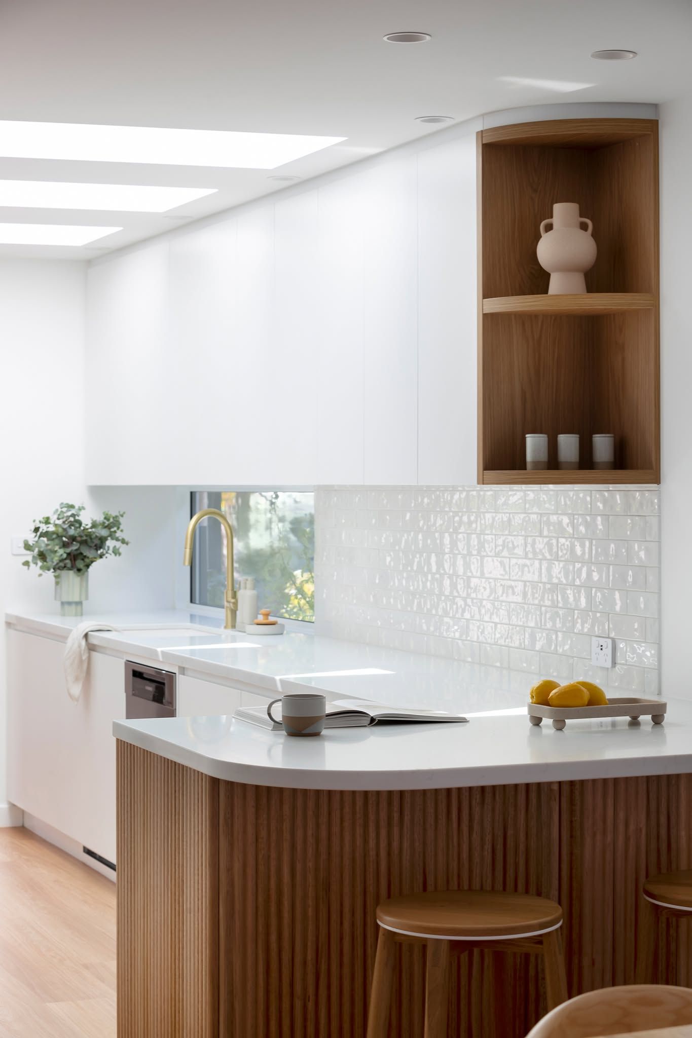 Bright Modern Kitchen with Wood Island, White Countertops, and Built-In Shelves with Decor — Complete Property Projects In Phillip, ACT