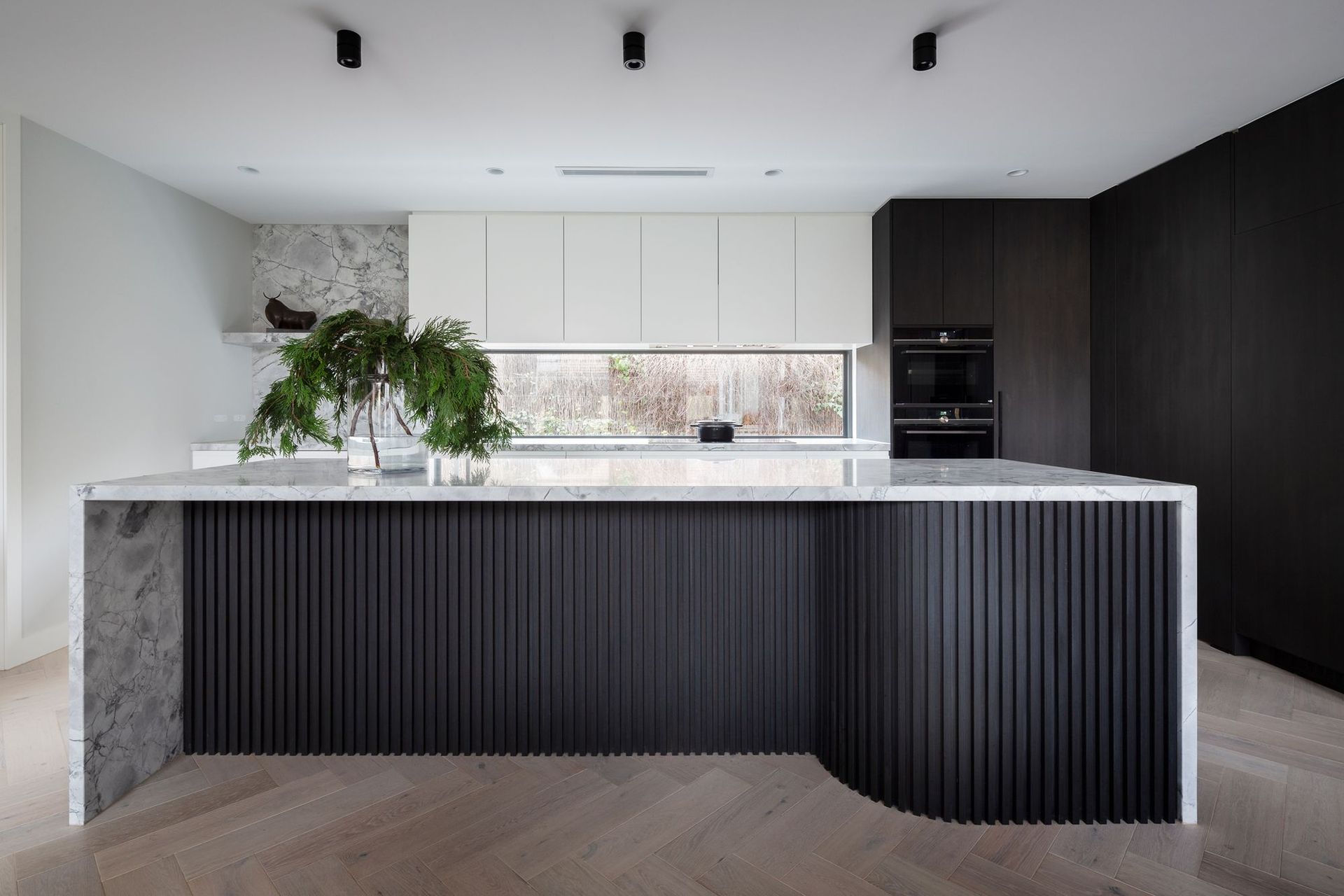 Modern Minimalist Kitchen with Dark Ribbed Island — Complete Property Projects In Phillip, ACT