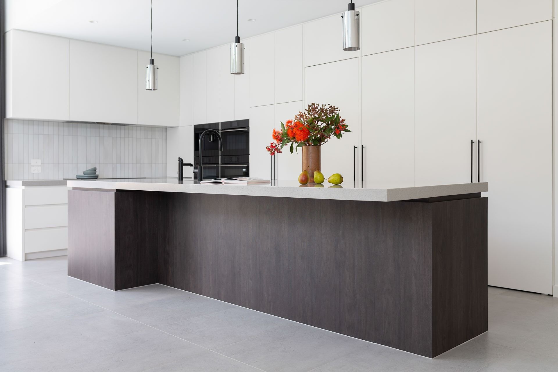 Modern White Kitchen with Dark Island, Pendant Lights — Complete Property Projects In Phillip, ACT
