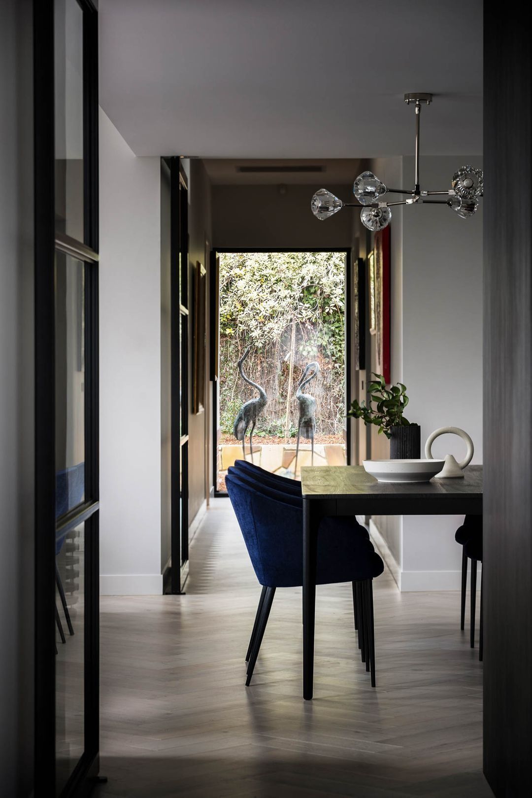 Modern Dining Area with Blue Chairs, White Table — Complete Property Projects In Phillip, ACT
