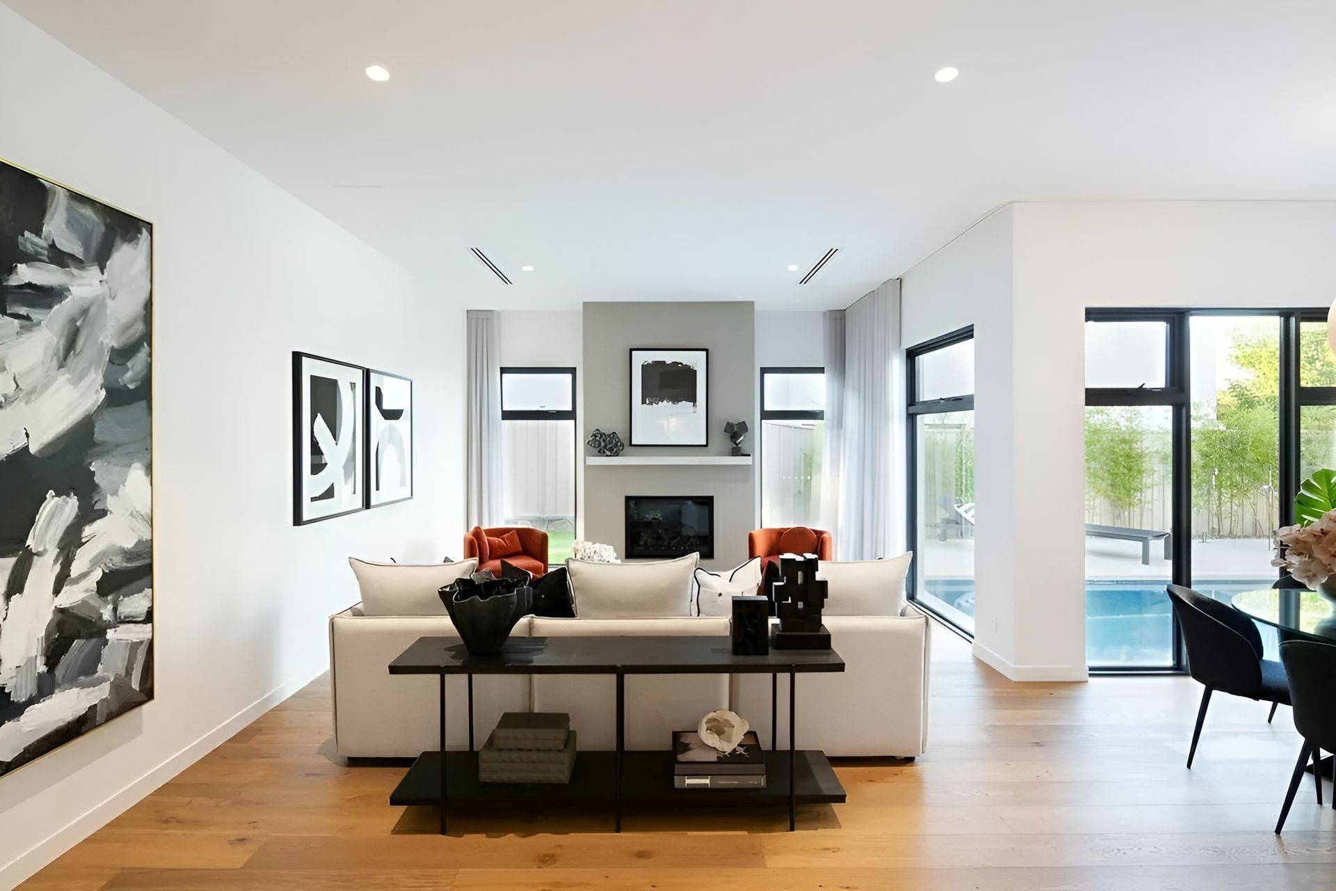 Bright Modern Living Room with White Sofas, Black Accents, Fireplace — Complete Property Projects In Phillip, ACT