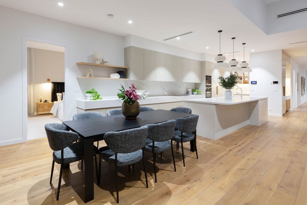 Modern Open-Plan Kitchen and Dining Area with Black Chairs — Complete Property Projects In Phillip, ACT