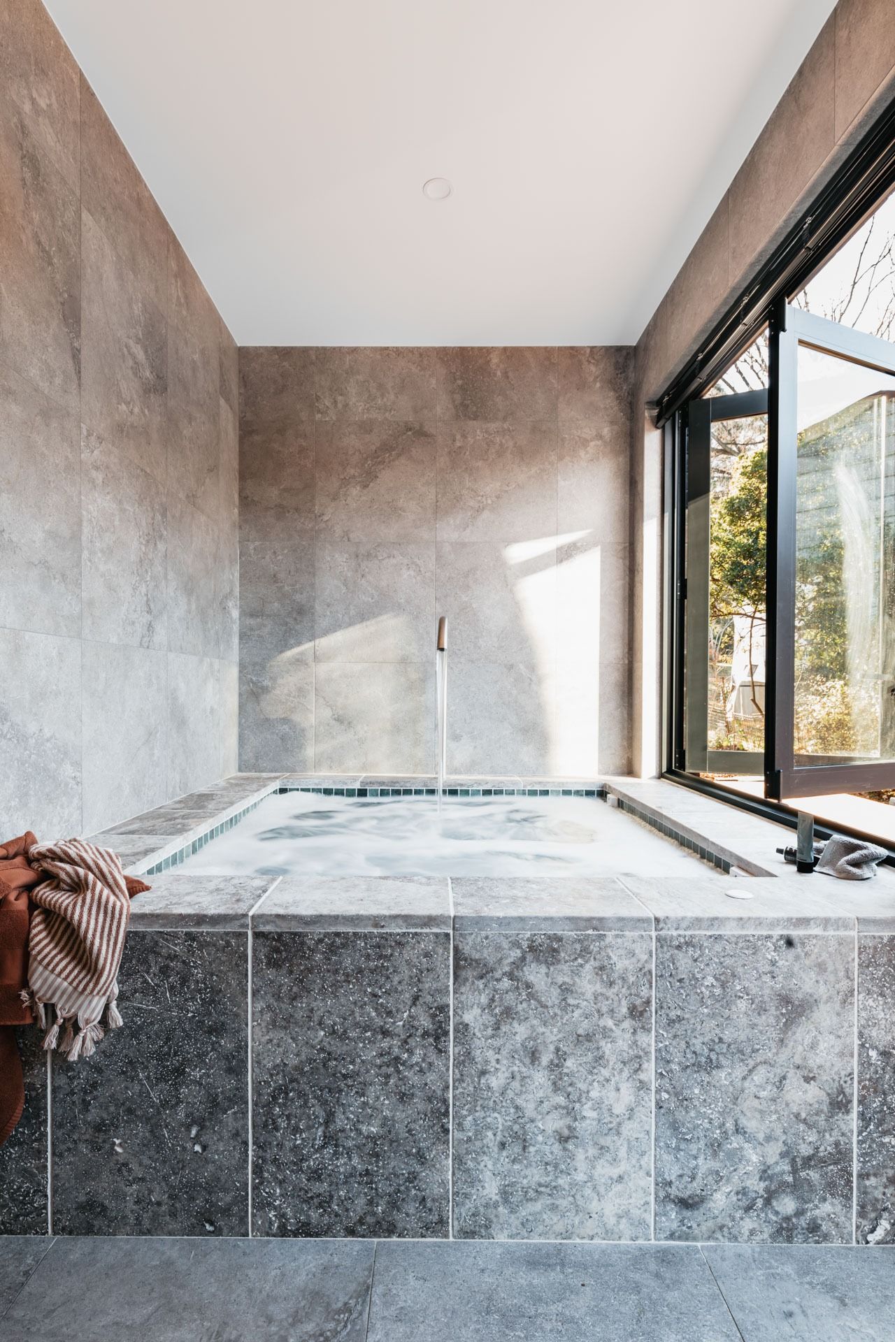 Modern Grey-Tiled Bathroom with A Built-In Soaking Tub — Complete Property Projects In Phillip, ACT